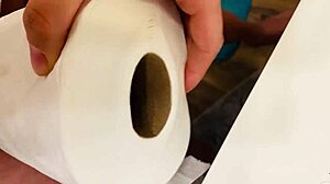 Masturbating with a tissue roll in a bathroom